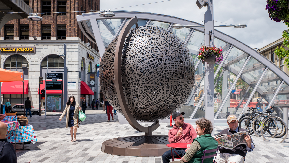 A rotation of public art is planned for the Berkeley BART plaza. First up is the sculpture, “Home,” a 14-foot tall metal globe that Berkeley artist Michael Christian originally made for Burning Man.