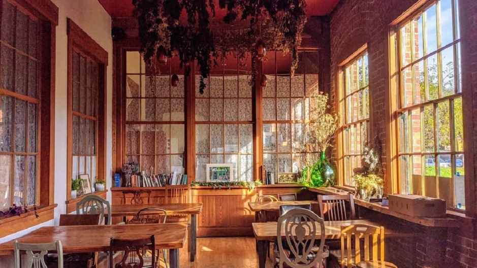 Sunlit interior of the Hidden Cafe featuring large windows.