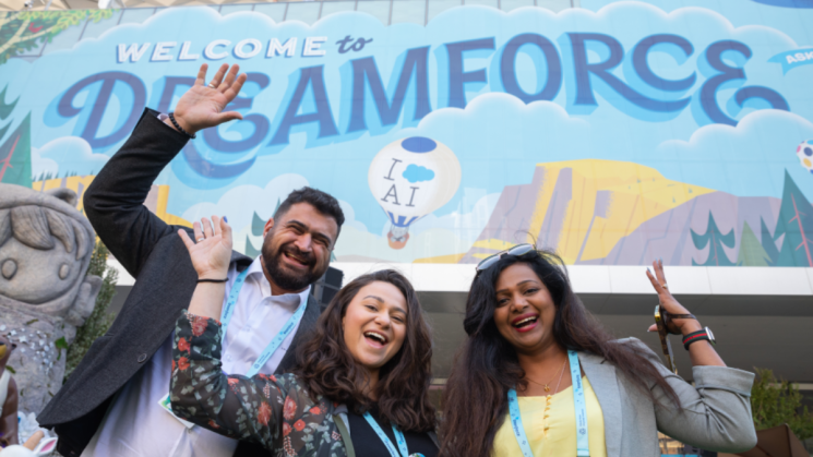 people pose in front of dreamforce postser