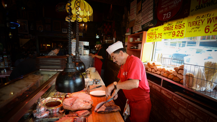 a chef cooks behind a counter at Tommy's Joynt