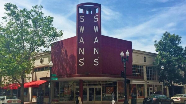 exterior red signage of swans market