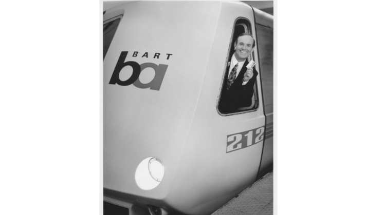 Robbie Schnell poses for a photo in a BART train.