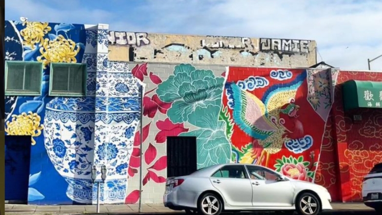 colorful mural showcasing asian culture on the side of a warehouse building