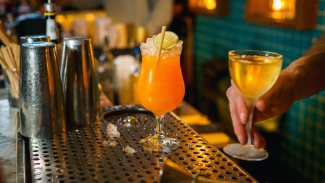 Visit this cozy hangout for craft cocktails, comfort bites, and a look through its curated bookstore.Photo courtesy of Visit Oakland.