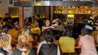 Don’t miss inventive martinis and creative hot dogs at this cool neighborhood bar. Photo courtesy of The Oaklandside (Carla Hernandez Ramirez).