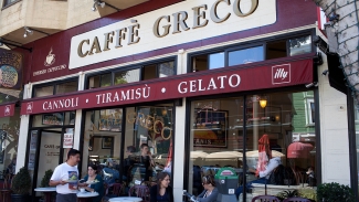 Stop by Caffe Greco for a warm drink and a tasty pastry. Photo courtesy of Table Agent.
