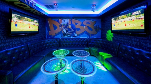 square room with neon basketball themed decor