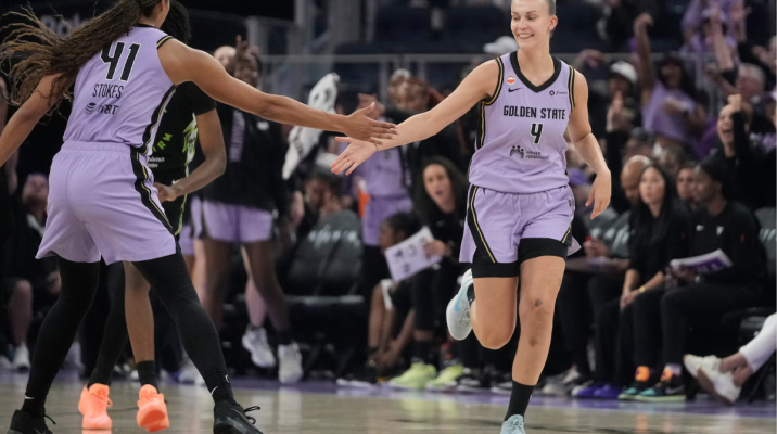 Golden State Valkyries embracing on the court at Chase Center